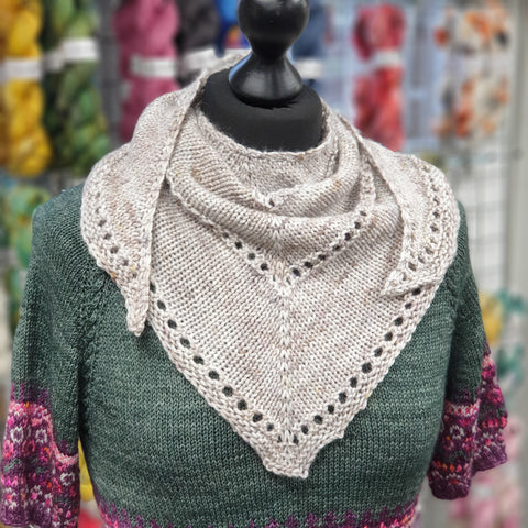 Small grey triangular shawl on a mannequin