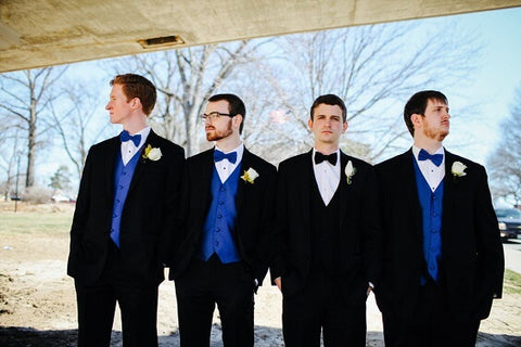 groomsmen in ties in lighter color than the suits