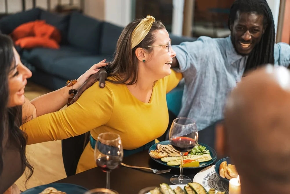 Friends sharing joyful meal each other