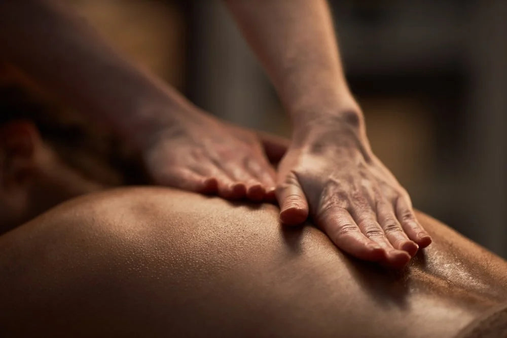 Hand massage applying oil on back