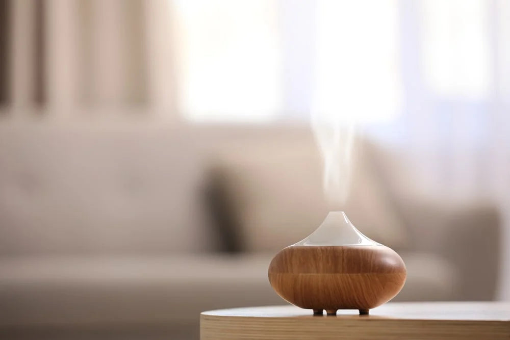 Modern essential oil diffuser on table