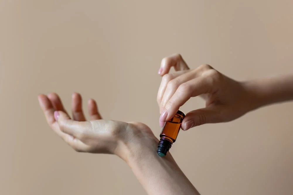 woman applying natural rollerball aroma oil