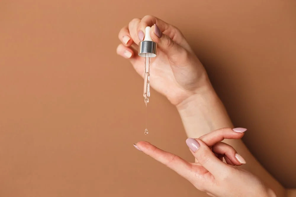 woman holding cosmetic serum