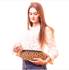 Woman wearing a geometric patterned sling bag around her waist