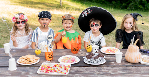 Kids dressed in halloween with sweets basket