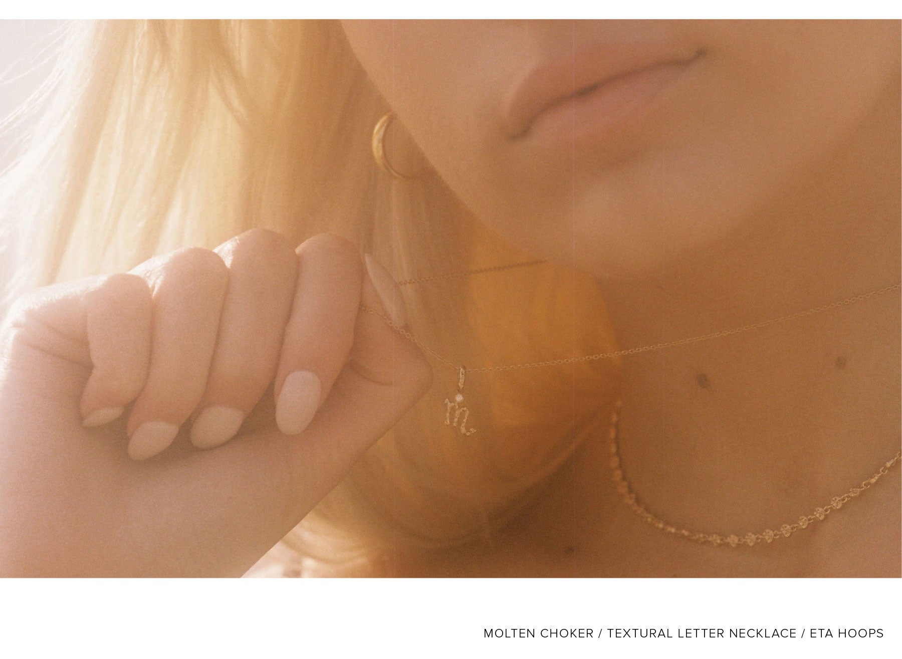 Close Up of Model Holding YCL Jewels Textural Letter Necklace