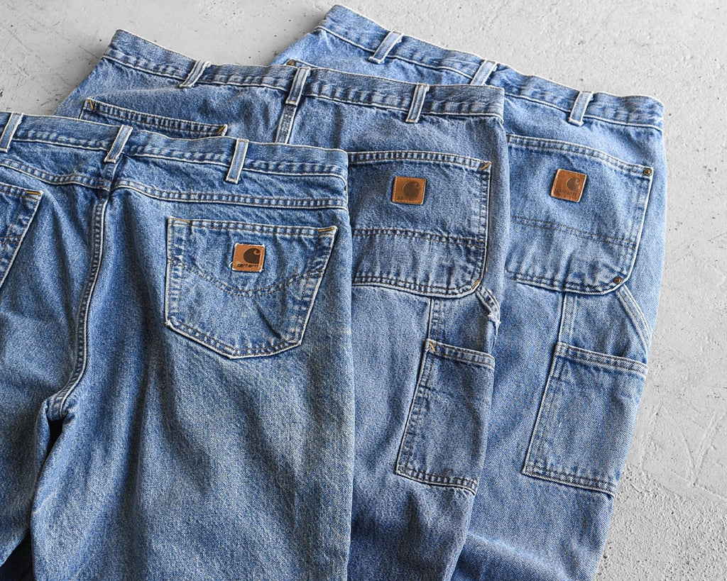 vintage carhartt jeans laid out