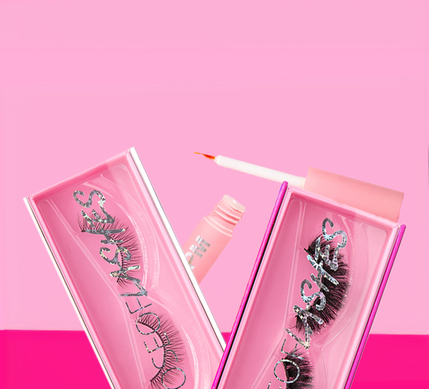 False eyelashes in pink packaging on a pink background.