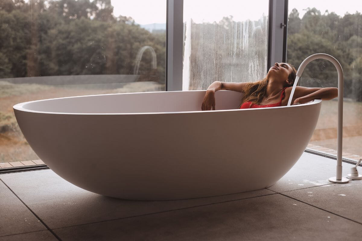 Woman Laying Down on a Ice Bath Tub