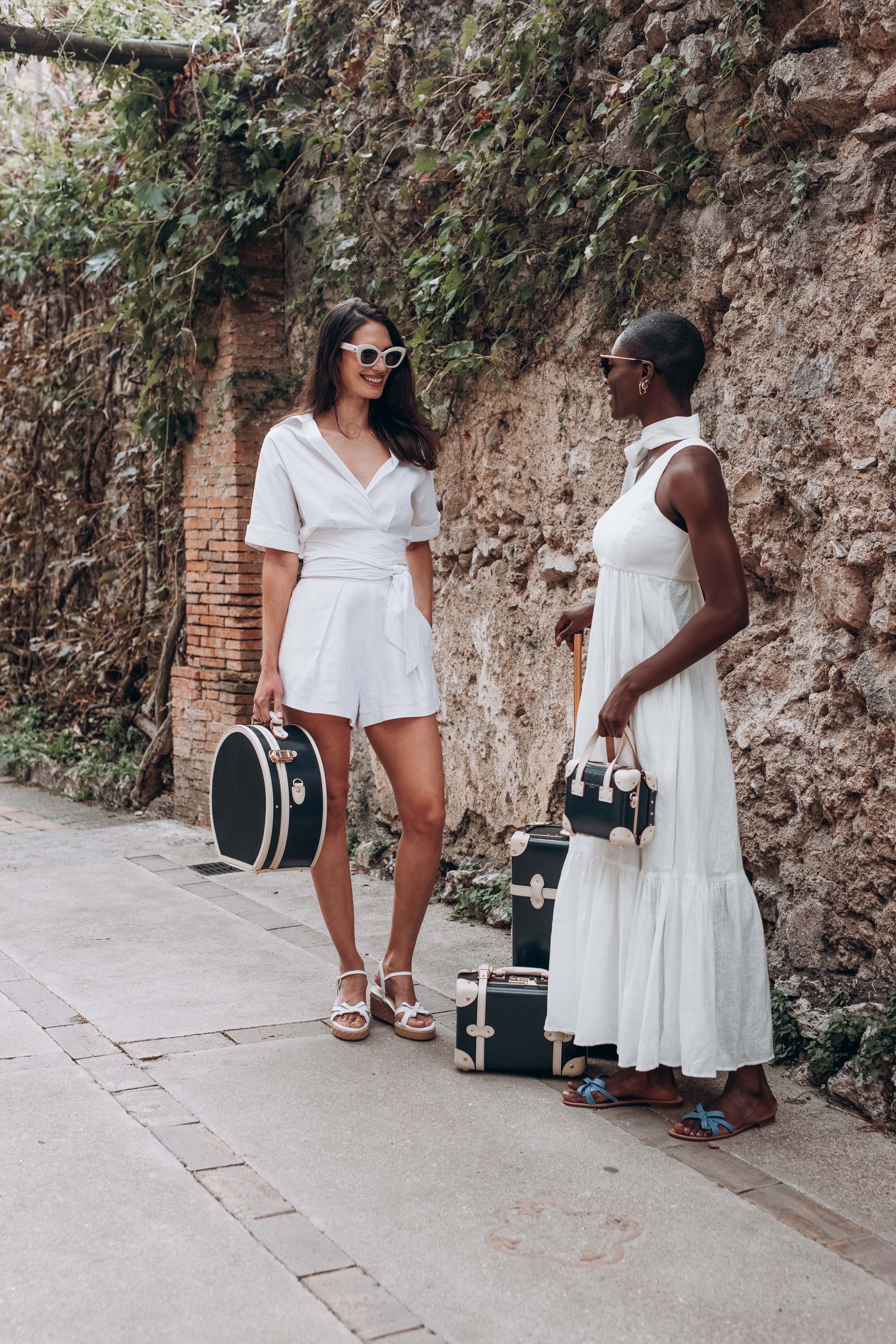 Women standing with vintage style luggage