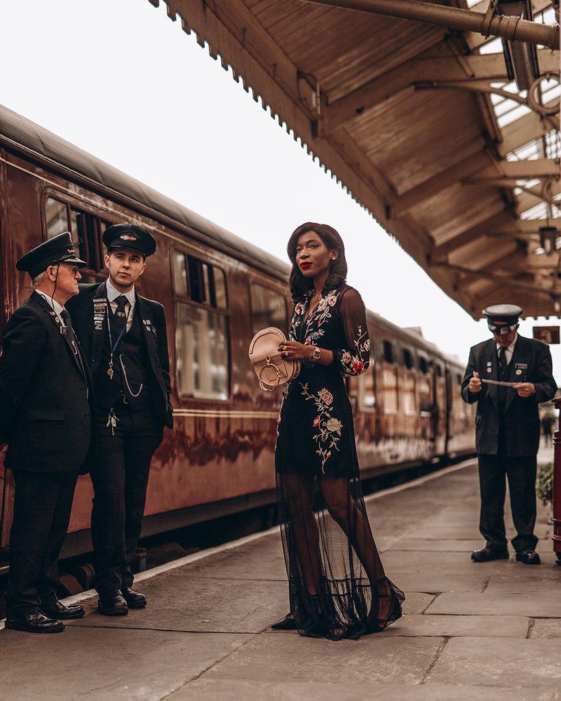Onyi Moss - self-taught photographer posing on a train platform