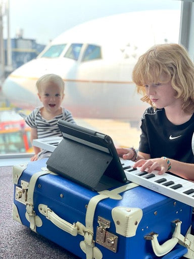 Image of children playing keyboard on SteamLine luggage case
