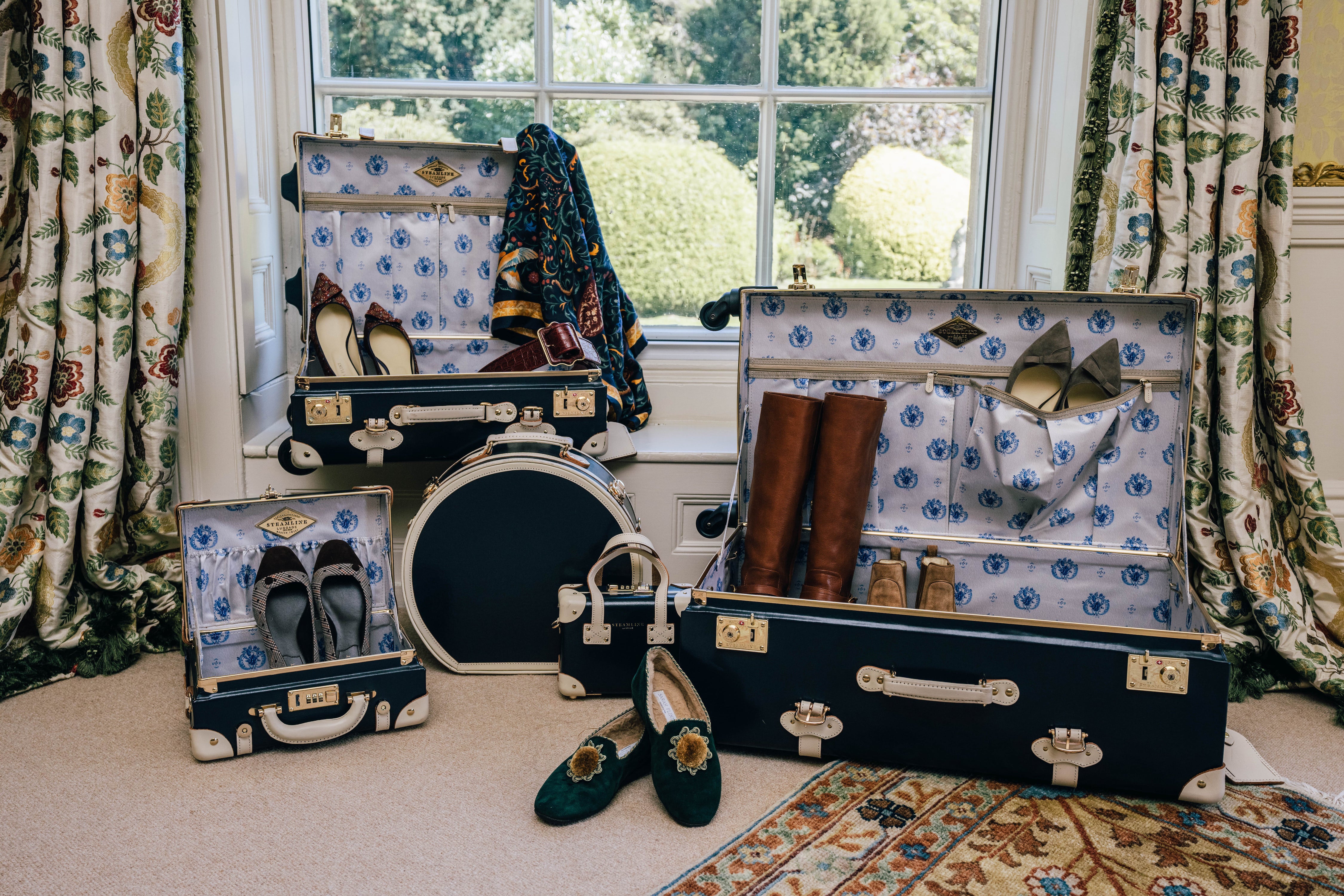 vintage style luggage array in front of a bay window