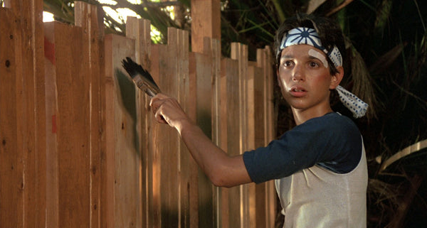 Daniel painting the fence in The Karate Kid movie