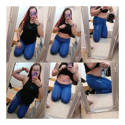 Woman Wearing Black Top & Blue Leggings Showing Her Body In The Mirror