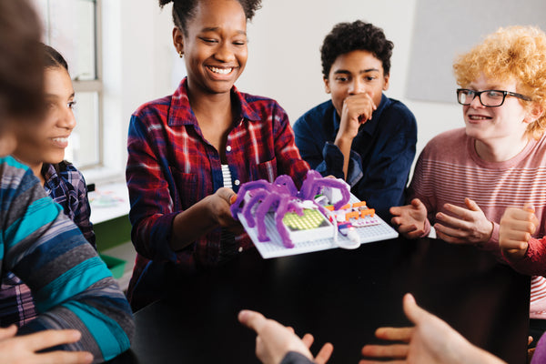 A girl presents her littleBits design to her classmates.