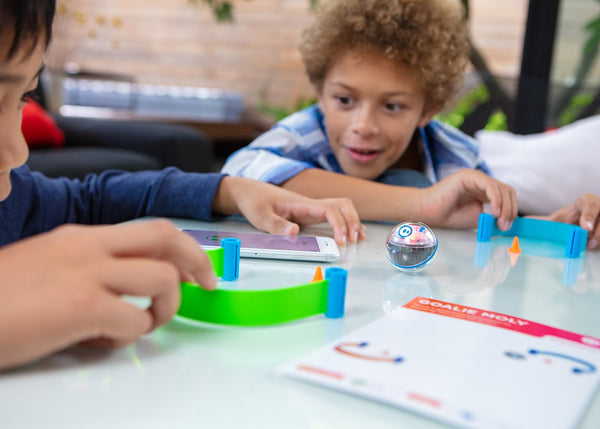 Two boys playing with mini activity kit. 