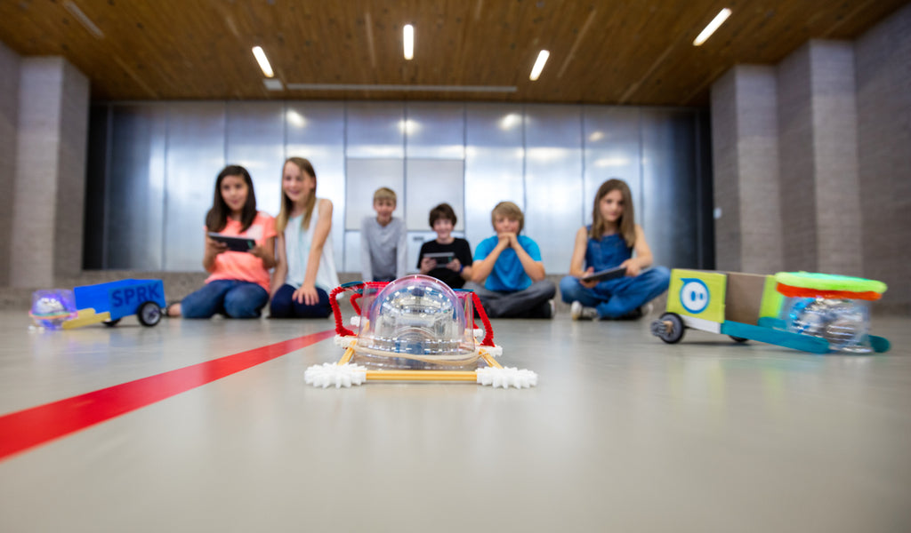 Kids build Sphero robot chariots as part of a STEM recess game.