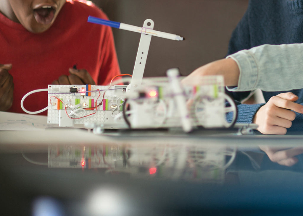 A boy builds a littleBits invention.