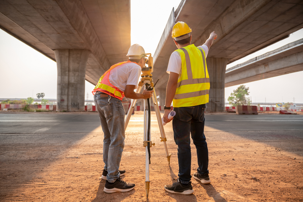 Two civil engineers surveying a construction site.