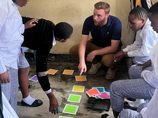 Author and Educator Adam Hill Works with students in Tanzania on learning English and Chinese with Sphero indi.