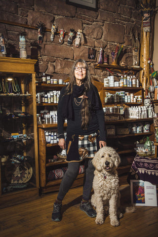 Phyllis and her golden doodle dog, Teddi stand in Winter Sun