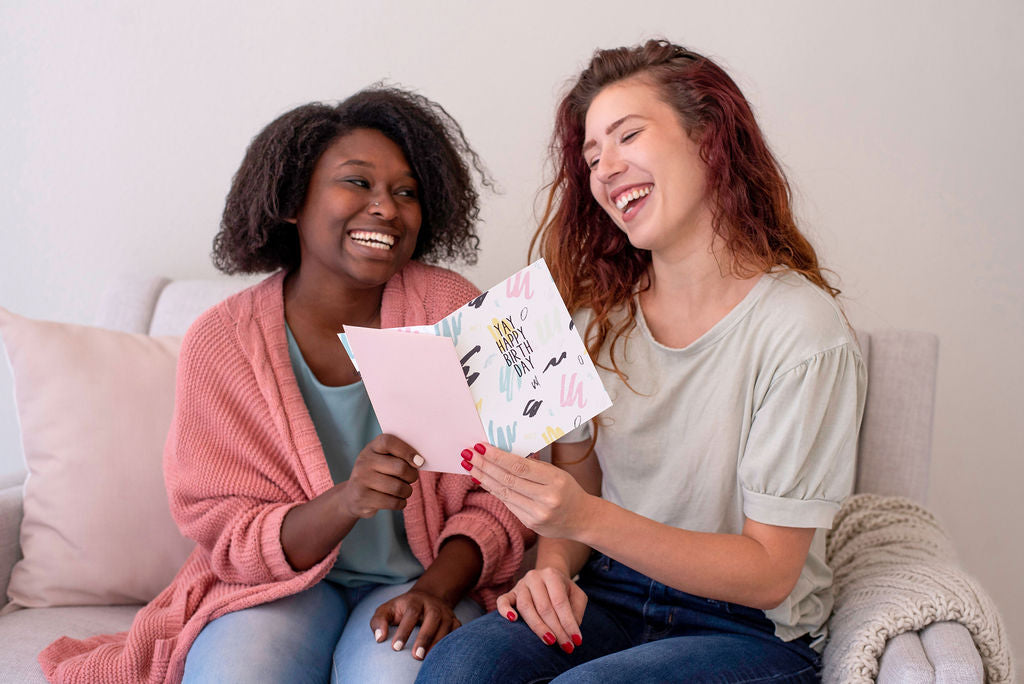 two women holding a birthday card