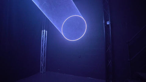 Laser Circle Cone Being Projected onto a black demo studio wall