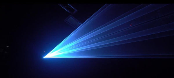 White and Blue Backdrop of Laser Effect in a dark Kvant Demo Studio