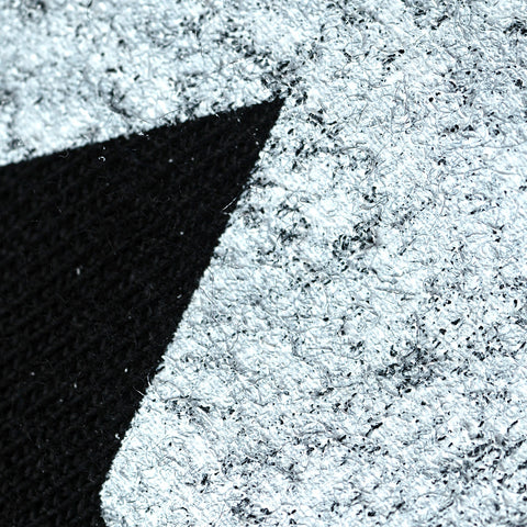 black shirt fibers poking through a white print
