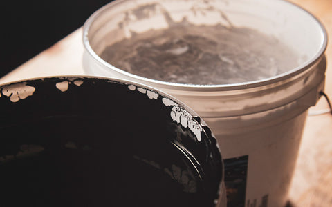 a gallon of white and a gallon of black water-based ink