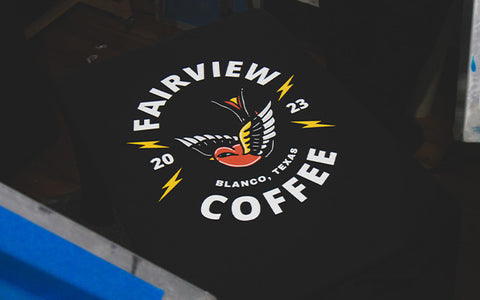 a black shirt with "fairview coffee" printed on it
