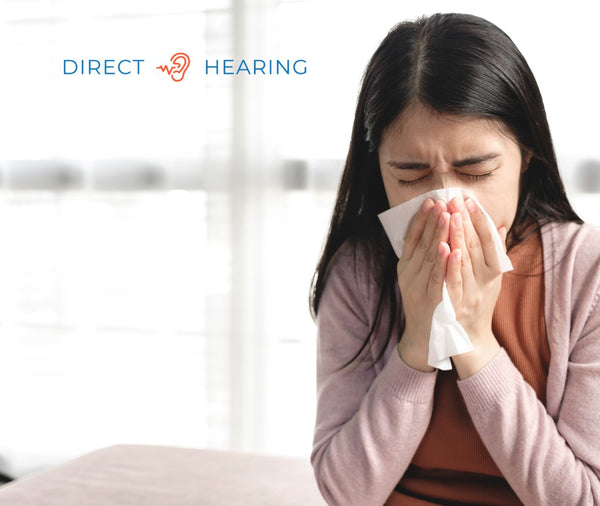 A person covering their mouth and nose with a tissue to prevent the spread of infection