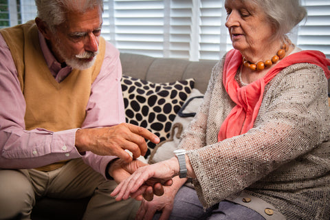 Elderly couple discussing about a personal alarm