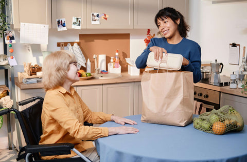 Daughter preparing meals for elderly mother