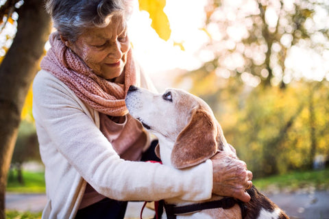 Senior with her pet dog in nature