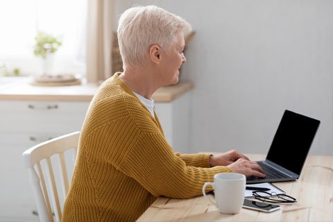 Elderly person using laptop