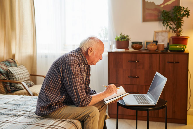 Elderly man looking at finances