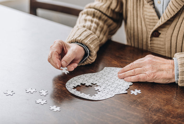 Elderly man doing a jigsaw