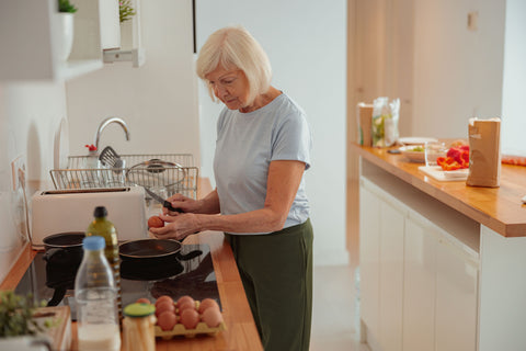 Elderly woman cooking for herself