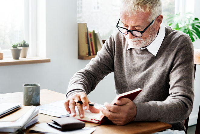 Elderly man signing a will