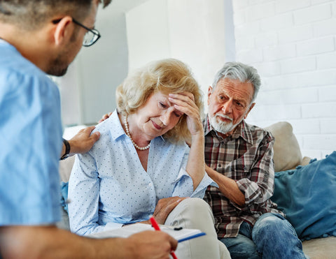 Elderly woman with depression and anxiety being consoled