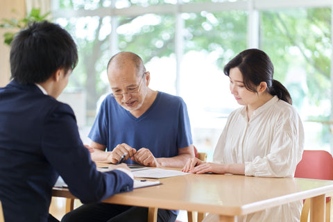 Old man with his daughter meeting financial advisor