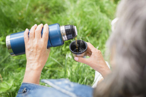 Elderly woman with a thermal flask