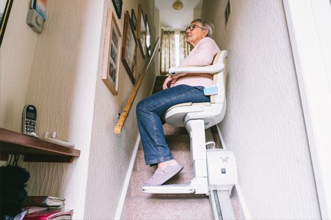 Older person using stairlift at home