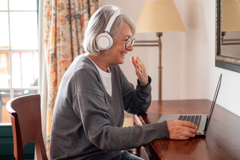 Happy elderly woman connecting with loved ones
