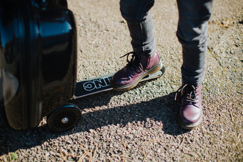 Kid with purple shoes on a Zinc Flyte scooter