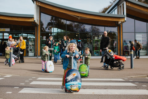 Kids riding Zinc Flyte scooters on zebra crossing crosswalk