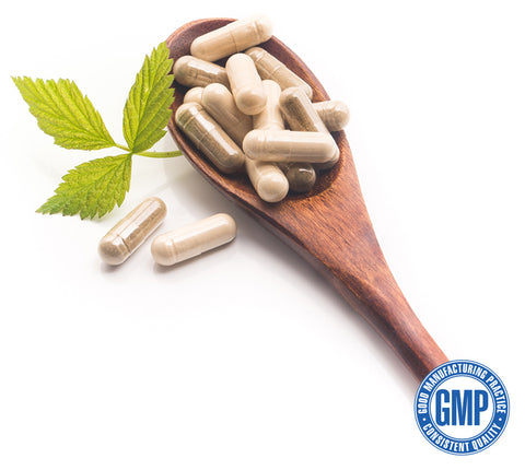 A wooden spoon with supplement pills 