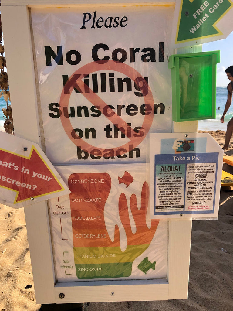 sign on beach for reef safe sunscreens